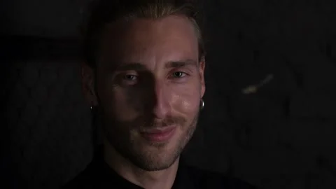 Attractive long-haired man smiling at the camera. close-up shooting.4K Stock Footage 137424324