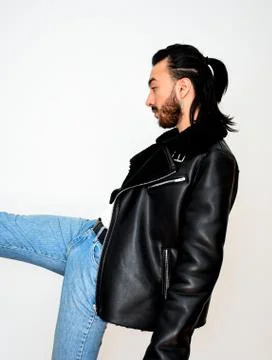 Attractive male model with a leather jacket posing Stock Photos