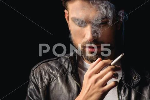 Attractive male smoker thinking with cigarette Stock Photos