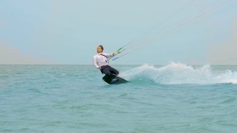 Attractive man with a beard riding a kite Stock Footage 102599913