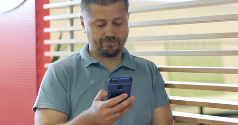 Attractive man with a beard talking on a mobile phone. Stock Footage 103260557