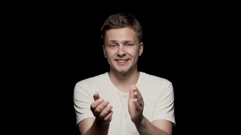 Attractive man clapping close up shot. Black background. Stock Footage 110997523