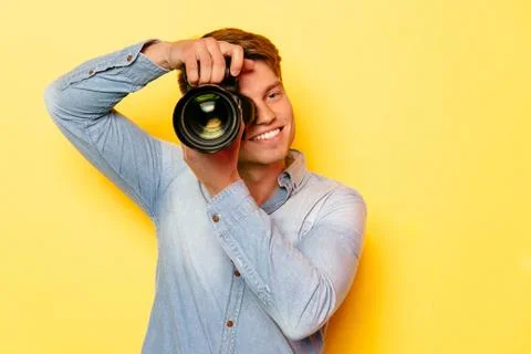 Attractive man with a digital camera Stock Photos