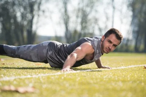 Attractive Man Doing Pushups Outside Stock Photos