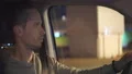 The attractive man driving the car on the night cityscape background 4k or 4k+ Resolution