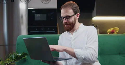 Attractive man engaged in software engineering working from home, concentrating Stock Footage 241838280