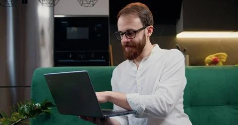 Attractive man engaged in software engineering working from home, concentrating Stock Photos