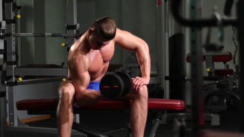 Attractive man exercising biceps at gym Stock Footage 77189075