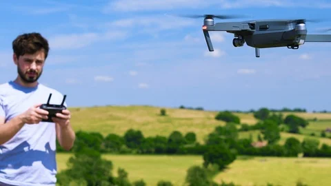 Attractive man flying a drone Stock Footage 91944873