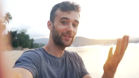 Attractive Man Having Video Chat and Saying Hello on Tropical Beach 4K Stock Footage 109090057