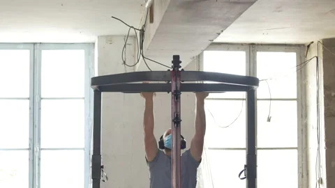 Attractive man in his 30's doing pull ups training in home gym during covid19 Stock Footage 142513738