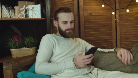 Attractive Man at home Using smart phone sending message on social. Stock Footage 147034356