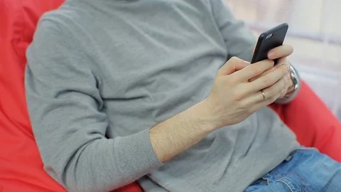 Attractive man at home using smartphone sending message on social media Stock Footage 73751703
