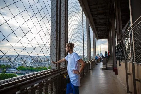 Attractive man inside the Eiffel tower Stock Photos