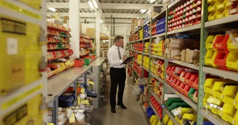 An attractive man inspecting product in a plastics manufacturing plant Stock Footage 52675459