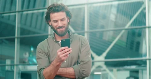 Attractive Man with Interesting Appearance standing in the Foreground. Stock Footage 130355421