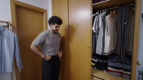 Attractive man looking in the mirror before going out Stock Footage 257590588