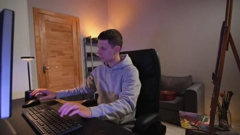 Attractive man multitasking in creative home office, working hard on computer Stock Footage 316149359