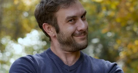 Attractive man pops into frame smiling and looking at the camera Stock Footage 101446568