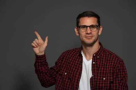 Attractive man posing on dark background Stock Photos