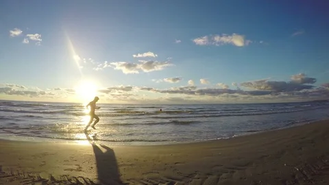 Attractive man running on the beach Stock Footage 71996023