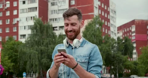 Attractive Man sitting at the Bus stop, waiting for his Tram. Stock Footage 130926094