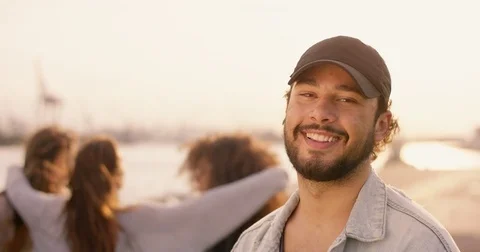Attractive man smiling into the camera while good looking women dancing in th Stock Footage 85082161