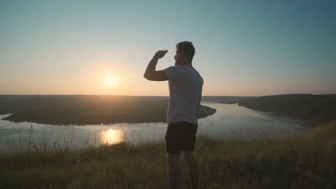 The attractive man standing on beautiful river background. slow motion Stock Footage 161014864