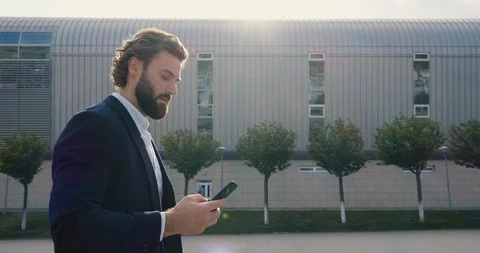 Attractive Man in Suit is walking down the streets of modern futures City.  Stock Footage 117690990
