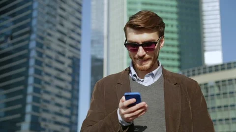 Attractive man using app on smartphone, smiling Stock Footage 68398032
