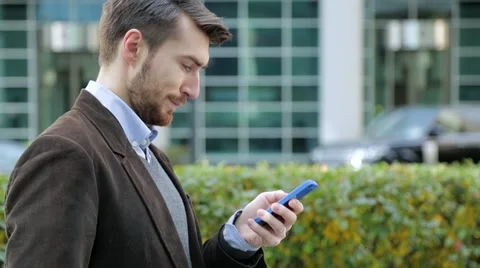 Attractive man using app on smartphone, smiling Video stock 68398214