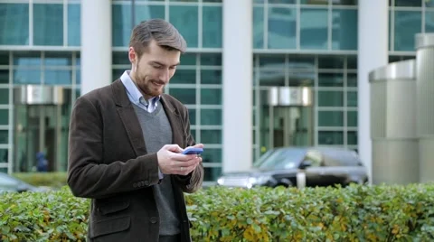 Attractive man using app on smartphone, smiling Stock Footage 68398296