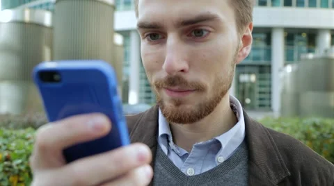Attractive man using app on smartphone, smiling (close-up) Stock Footage 68398543