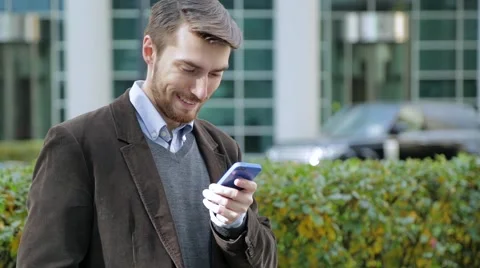 Attractive man using app on smartphone, smiling Video stock 68399891