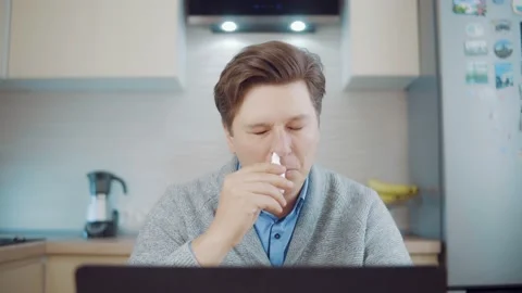 Attractive man using a cold spray Stock Footage 148814028