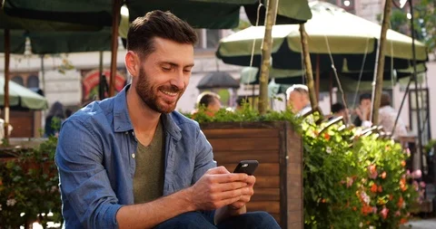 Attractive Man Using his Phone for Social Network and Using Apps. Stock Footage 99234982