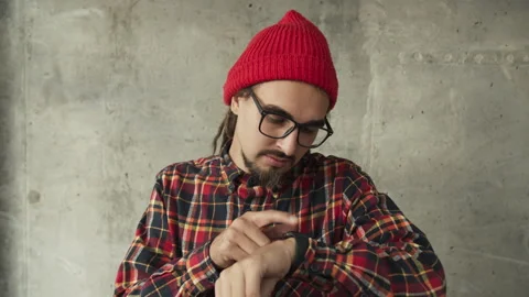 Attractive man using his smartwatch and controlling his smart home, hipster Stock Footage 140520334