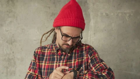 Attractive man using his smartwatch and controlling his smart home, hipster Stock Footage 142454792