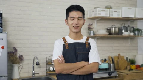 Attractive man wearing an apron with folded arms Video stock 201174572