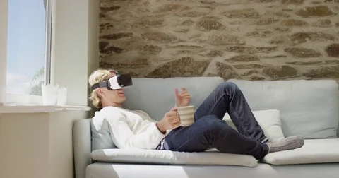 Attractive man wearing virtual reality headset video chatting online dating app Stock Footage 73366025