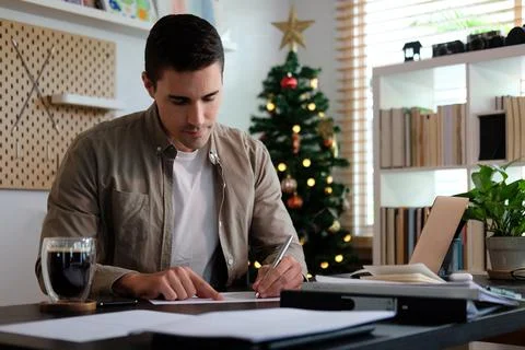 Attractive man working with computer laptop at home. Stock Photos