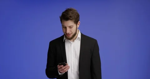 Attractive man working on his smartphone and smiling Stock-Footage 99460065