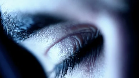 Attractive man's closed eye opening in the dark- macro Stock Footage 90079388