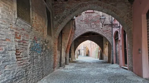 Attractive medieval street via Volta with vaults and arches. Ferrara. Italy. 4K Stock Footage 295042547