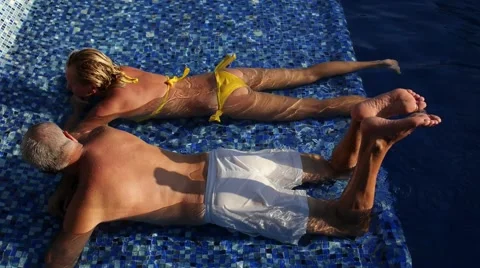 Attractive Middle Aged Couple Resting in Resort Pool on Holidays Stock Footage 52867856