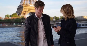 Attractive millennial couple in Paris using smartphone Stock Footage 85784976