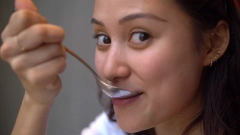 Attractive Mixed Girl Eats Cake and Smiles to Camera Closeup Slo Mo 4k Stock Footage 122988454