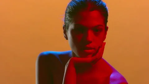 Attractive model in blue-red light supports head confident Stock-Footage 341125468