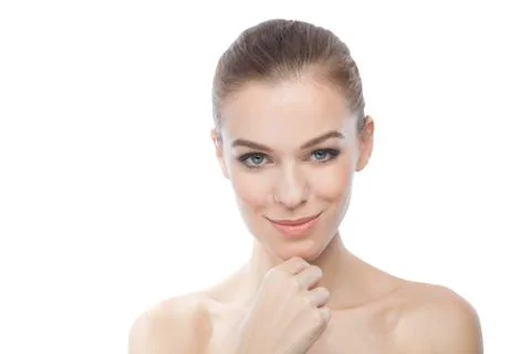 Attractive model smiling while touching her skin, over white background Stock Photos