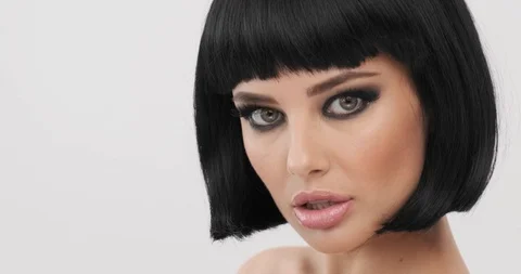 Attractive model turns and looking. Young woman with smokey eyes makeup.  Clo Stock Footage 125791508